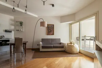 a living room with a couch and a table at GuestHost - Porta Portese Modern Terrace Apartment in Rome