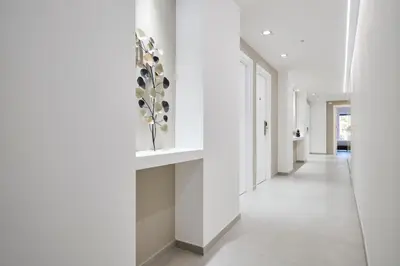 a hallway in a house with white walls and white floors at San Giovanni Retreat in Rome