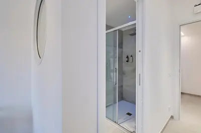 a glass walk in closet with a mirror at San Giovanni Retreat in Rome
