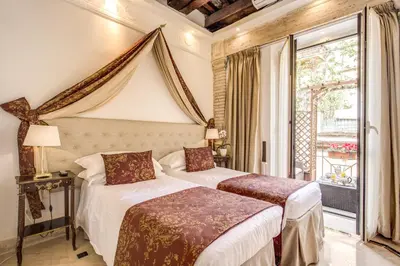 two beds in a room with a window at Pantheonview - Luxury Suites in Rome