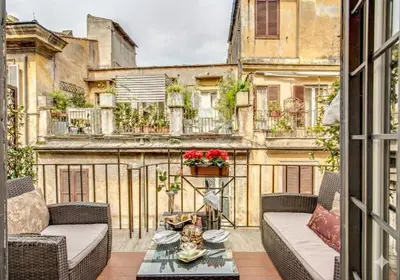 a balcony with couches and a table in front of a building at Pantheonview - Luxury Suites in Rome
