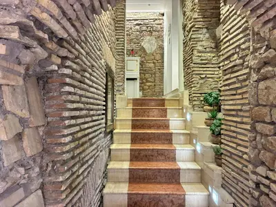 a brick hallway with stairs in a house at Pantheonview - Luxury Suites in Rome