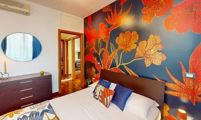 a bedroom with a bed with a flower mural on the wall at Margot - Quiet and Elegant with Free Parking in Rome