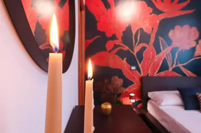 a room with two candles on a table with a painting at Margot - Quiet and Elegant with Free Parking in Rome
