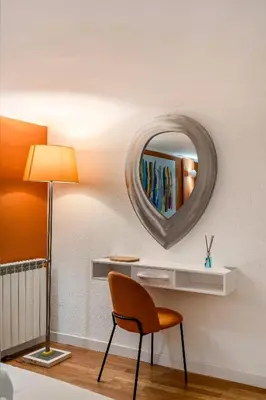 a room with a chair and a mirror on the wall at Piazza Navona Suite - Pantheon in Rome