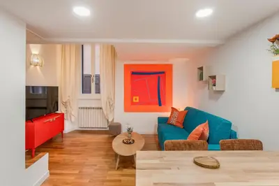 a living room with a blue couch and a table at Piazza Navona Suite - Pantheon in Rome