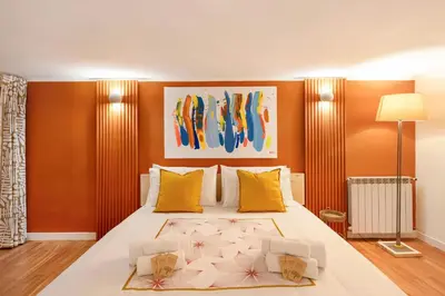 a bedroom with a large bed with yellow pillows at Piazza Navona Suite - Pantheon in Rome