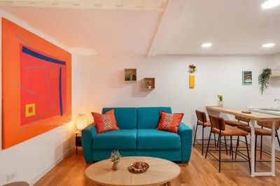 a living room with a blue couch and a table at Piazza Navona Suite - Pantheon in Rome