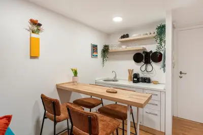 a kitchen with a wooden table and chairs at Piazza Navona Suite - Pantheon in Rome