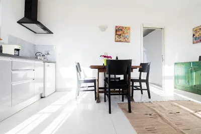 a kitchen with a dining room table and chairs at St John Basilica Lovely Tower Apartment in Rome