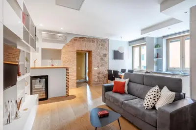 a living room with a couch and a fireplace at Première in Rome