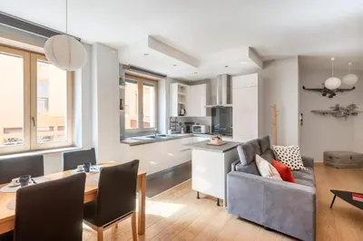 a kitchen and living room with a couch and a table at Première in Rome