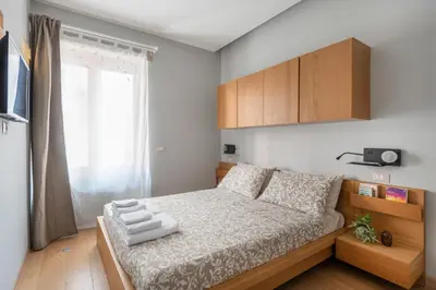 a small bedroom with a bed and a window at Première in Rome