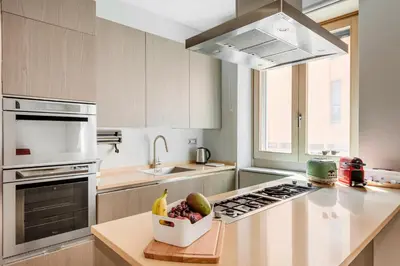 a kitchen with a bowl of fruit on a counter at Première in Rome