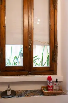a kitchen sink with a wooden window on a counter at Al campanile Trastevere apartment in Rome