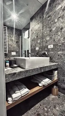 a bathroom with a sink and a large mirror at Archimede 35 One step away from the center in Rome