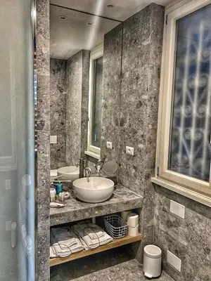 a bathroom with two sinks and a mirror at Archimede 35 One step away from the center in Rome