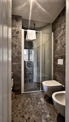 a bathroom with a shower and a toilet and a sink at Archimede 35 One step away from the center in Rome