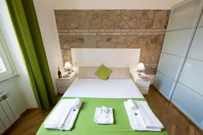 a bedroom with a bed with two towels on it at The Great Beauty in Rome