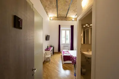 a hallway with a bathroom with a sink and a mirror at The Great Beauty in Rome