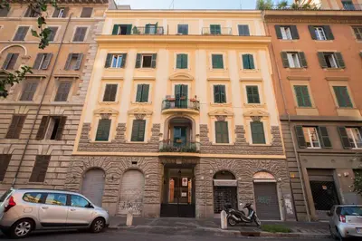 a large building with cars parked in front of it at The Great Beauty in Rome