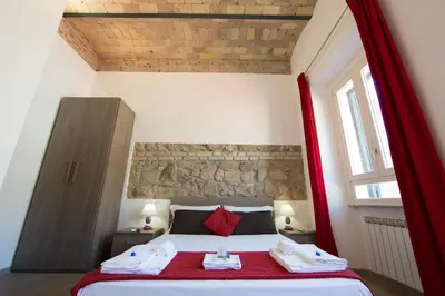 a bedroom with a bed with towels on it at The Great Beauty in Rome