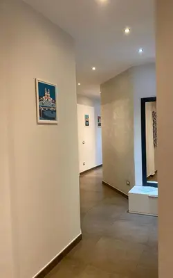 a hallway with a wall with a picture on it at Casa Fontana - zona San Giovanni Colosseo in Rome