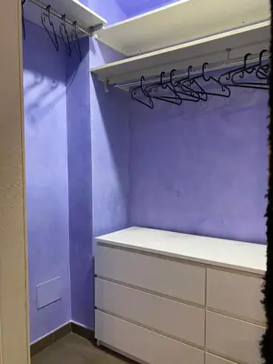 a closet with purple walls and white drawers at Casa Fontana - zona San Giovanni Colosseo in Rome