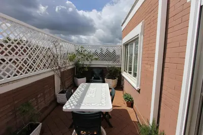 a small patio with a white table on a balcony at Pironti Flat in Rome