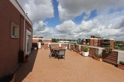 a patio with a table and chairs on a balcony at Pironti Flat in Rome