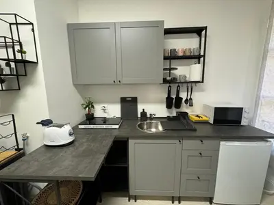 a kitchen with white cabinets and a counter top at rome via veneto in Rome
