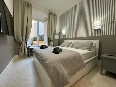 a bedroom with a bed with two teddy bears on it at rome via veneto in Rome