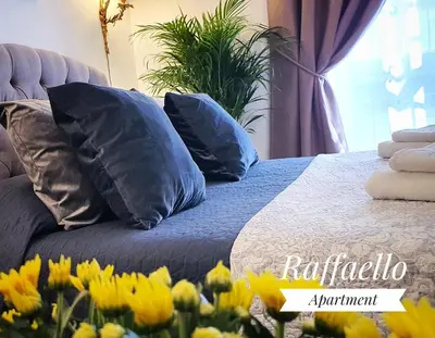 a bed with blue pillows in a bedroom with yellow flowers at Raffaello Apartment in Rome