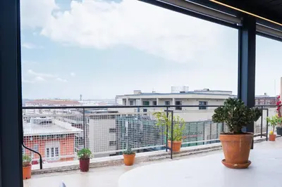 a view from the balcony of a building with potted plants at Attico Esclusivo Trastevere with Rooftop Terrace in Rome