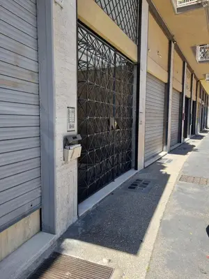 a row of garage doors on a building at Attico Esclusivo Trastevere with Rooftop Terrace in Rome