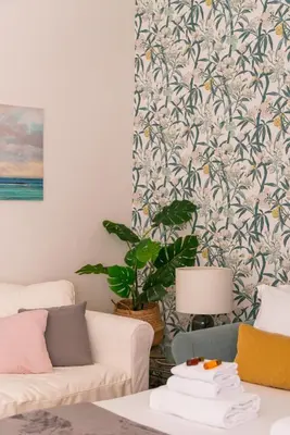 a living room with a couch and a plant at Appartamento via Quintino Sella in Rome
