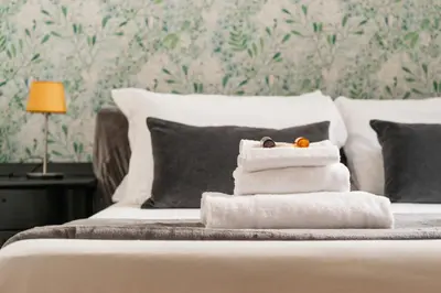 a pile of towels sitting on top of a bed at Appartamento via Quintino Sella in Rome