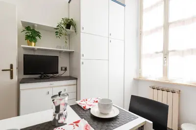 a small dining room with a table and a tv at Appartamento via Quintino Sella in Rome