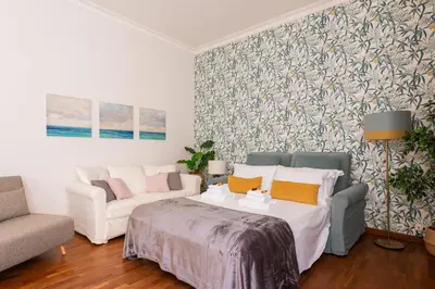a living room with a bed and a couch at Appartamento via Quintino Sella in Rome