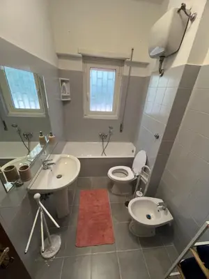 a bathroom with two sinks and a toilet and a tub at Paki House Luxury in Rome