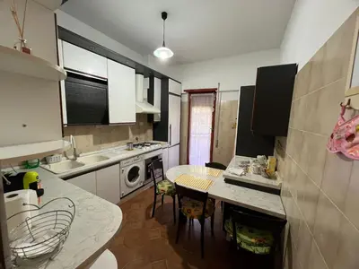 a kitchen with a counter and a table in it at Paki House Luxury in Rome