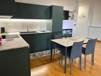 a kitchen with a table with chairs and a laptop on it at Del Vecchio Apartment in Rome
