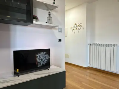 a living room with a large flat screen tv on a wall at Del Vecchio Apartment in Rome