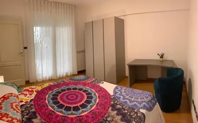 a bedroom with a bed with a colorful pillow on it at Del Vecchio Apartment in Rome