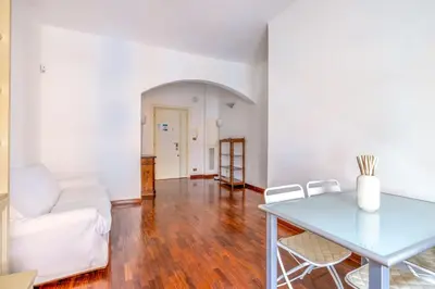 a living room with a white couch and a table at St Peter House by Varental in Rome