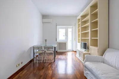 a living room with a table and a couch at St Peter House by Varental in Rome