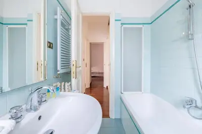 a bathroom with a sink and a tub and a mirror at St Peter House by Varental in Rome