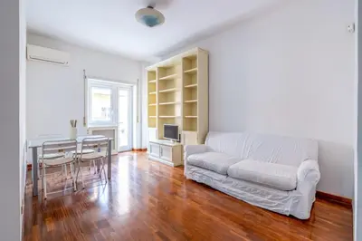 a living room with a white couch and a table at St Peter House by Varental in Rome