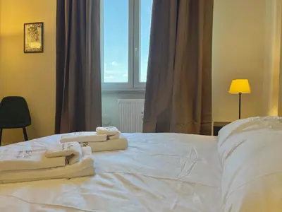 a bed with towels on it with a window at Onesti House - San Paolo in Rome