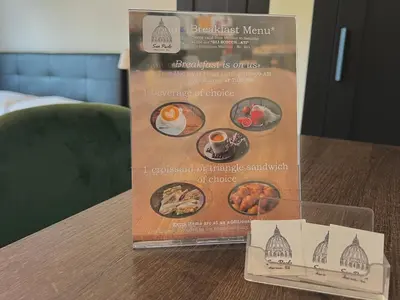 a box of breakfast menu on a table at Onesti House - San Paolo in Rome